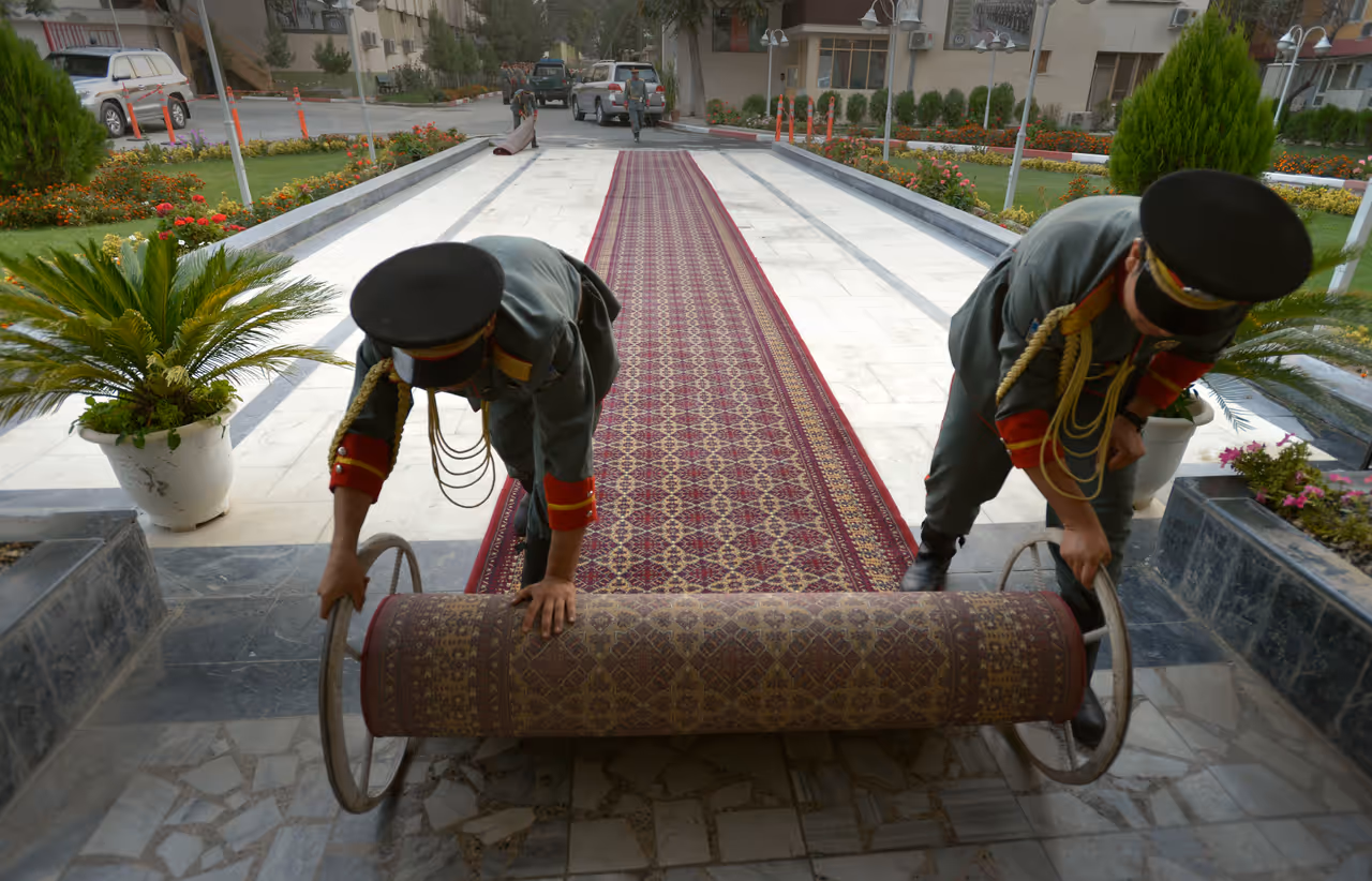 Honor guardsmen in Kabul roll out the red carpet