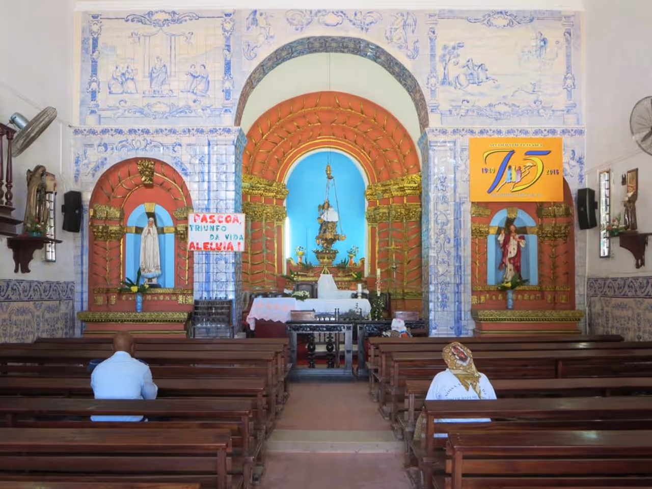 Blue ceramic tiles and a rose-colored marble altar in the Igreja de Nossa Senhora da Nazaré in Luanda, Angola.