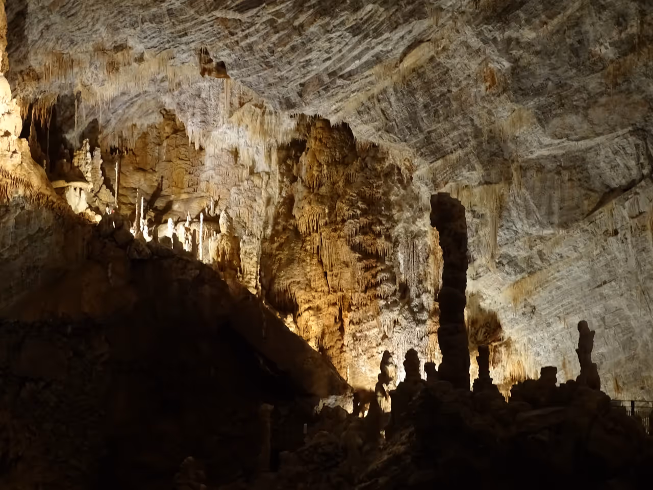 Stalagmites and stalactites inside the illuminated cavern of the Giant Chasm of Cabrespine
