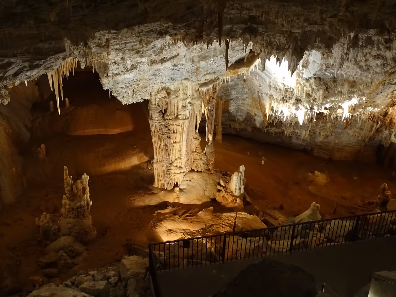 Large cavern interior of Gouffre Geant de Cabrespine showing illuminated stalactites and stalagmites
