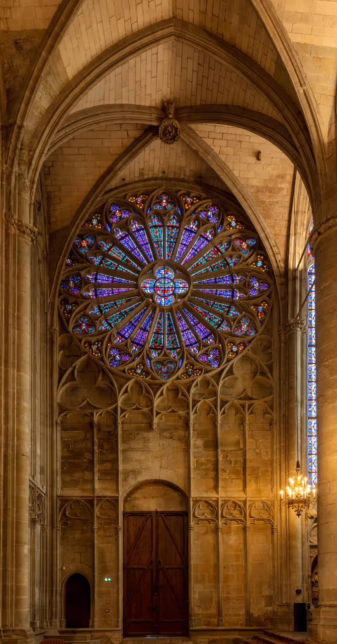 Stained glass rose window inside the Basilica of Saints Nazarius and Celsus in Carcassonne