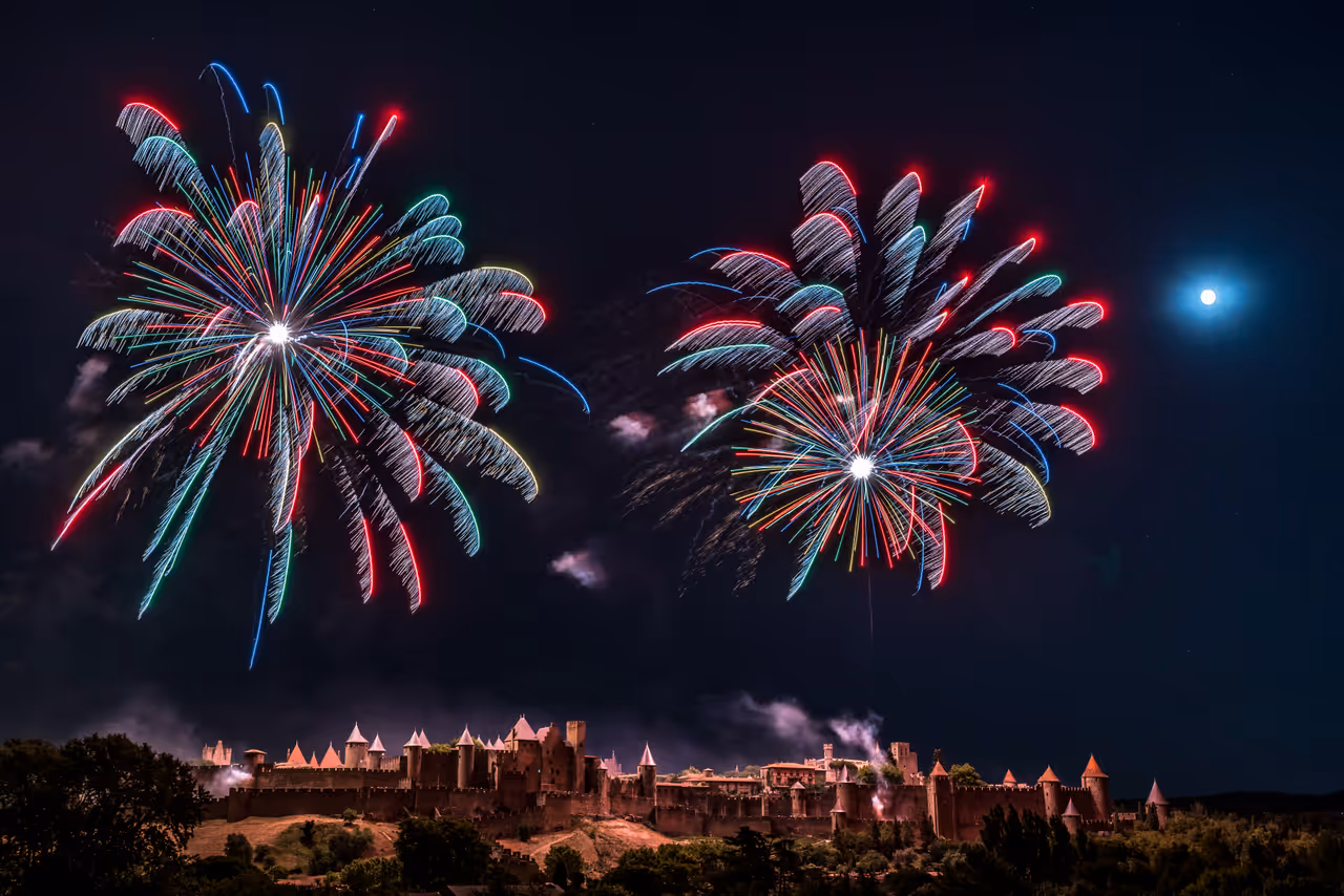 Fireworks illuminating the night sky above the illuminated medieval fortress of Carcassonne
