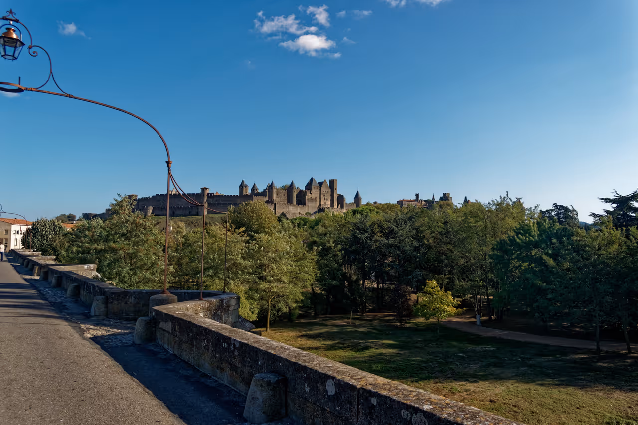 View of the medieval fortified city of Carcassonne from the Pont Vieux bridge on a sunny day