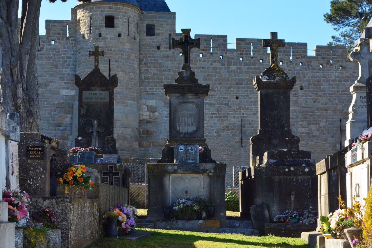 Historic graves at Cimetière de la Cité outside the Narbonne Gate of Carcassonne's fortified medieval city