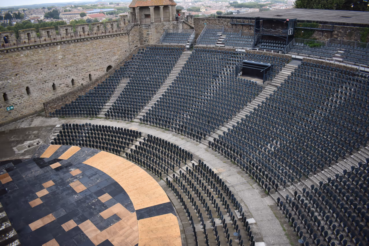 Open-air Théâtre Jean-Deschamps amphitheatre with rows of seating inside the medieval walled Cité de Carcassonne