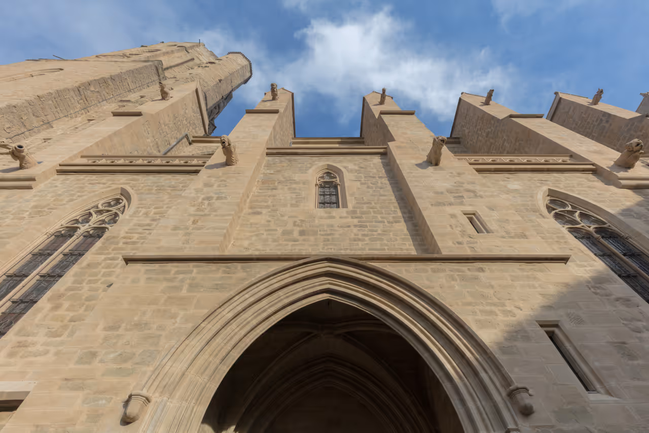 Gothic facade of the Church of Saint Vincent in Carcassonne showing stone masonry and gargoyles