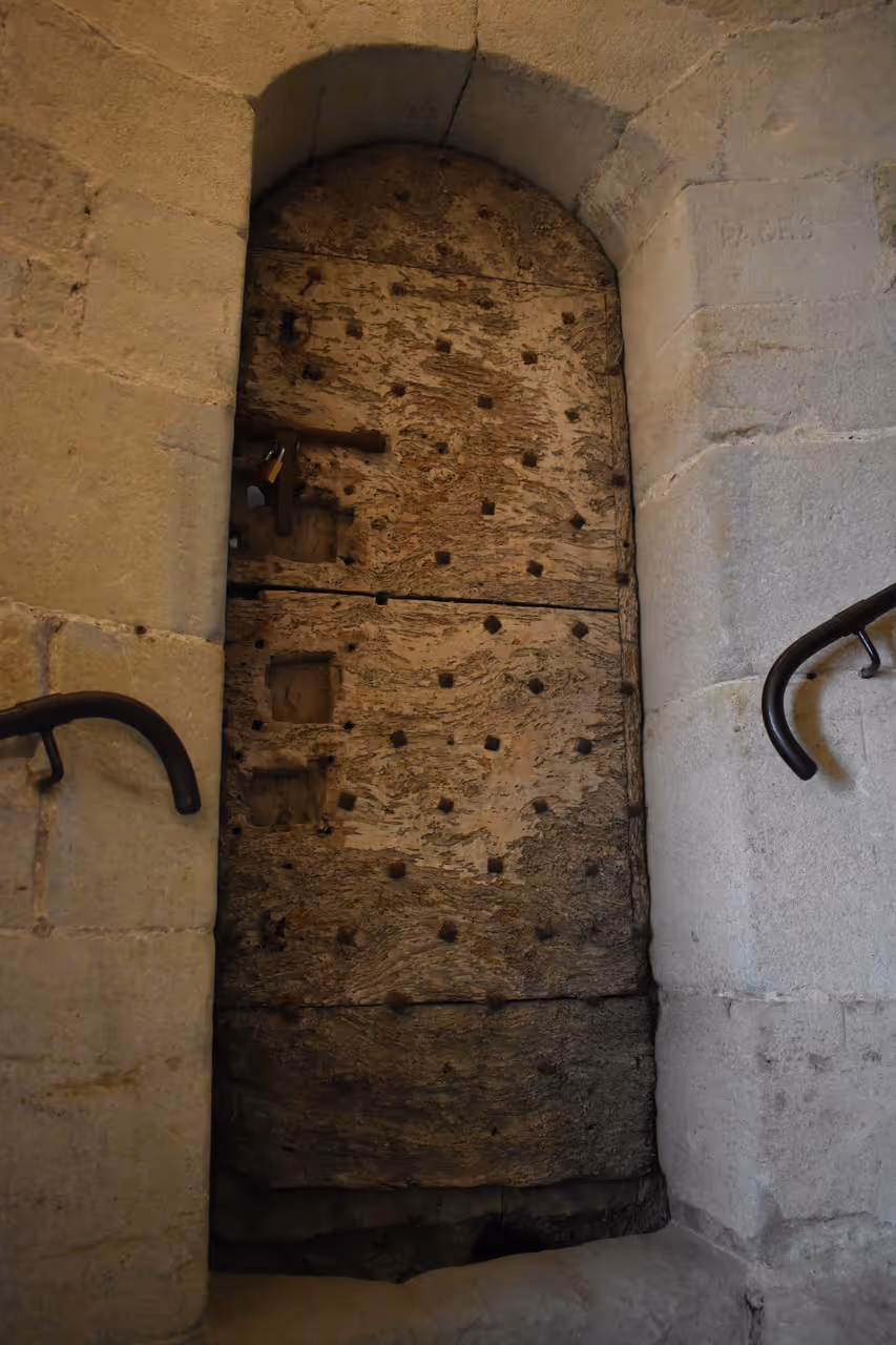 Ancient wooden door inside the bell tower of Saint-Vincent Church in Carcassonne