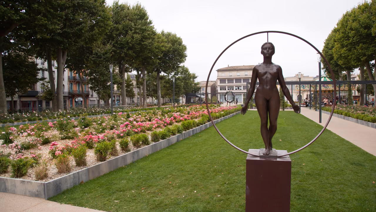 Bronze statue of a standing figure inside a ring at Square Gambetta in Carcassonne