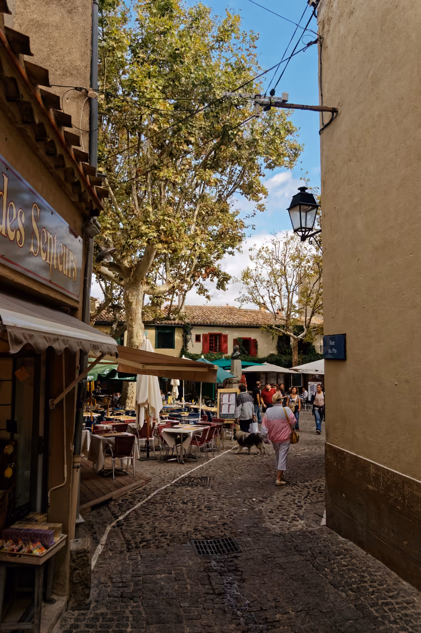 Cobblestone street of Rue du Plo leading towards Place Marcou in the medieval Cité of Carcassonne