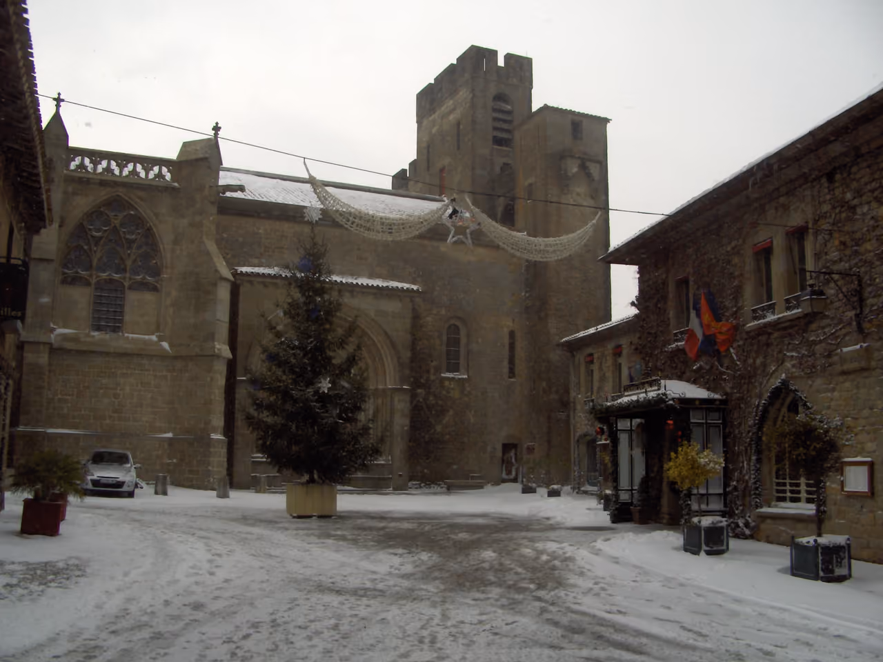 Snowy courtyard outside the Basilica of Saints Nazarius and Celsus in the medieval city of Carcassonne during winter
