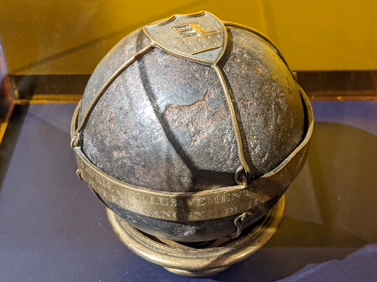 Souvenir cannonball from the 1834 Republican insurrection housed in Gadagne museum with an engraved metal band and coat of arms