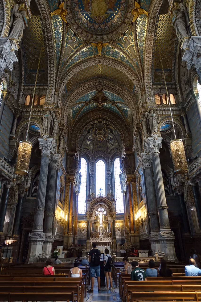 The interior of the Basilica of Notre-Dame de Fourviere showing its ornate, gilded ceilings and altar