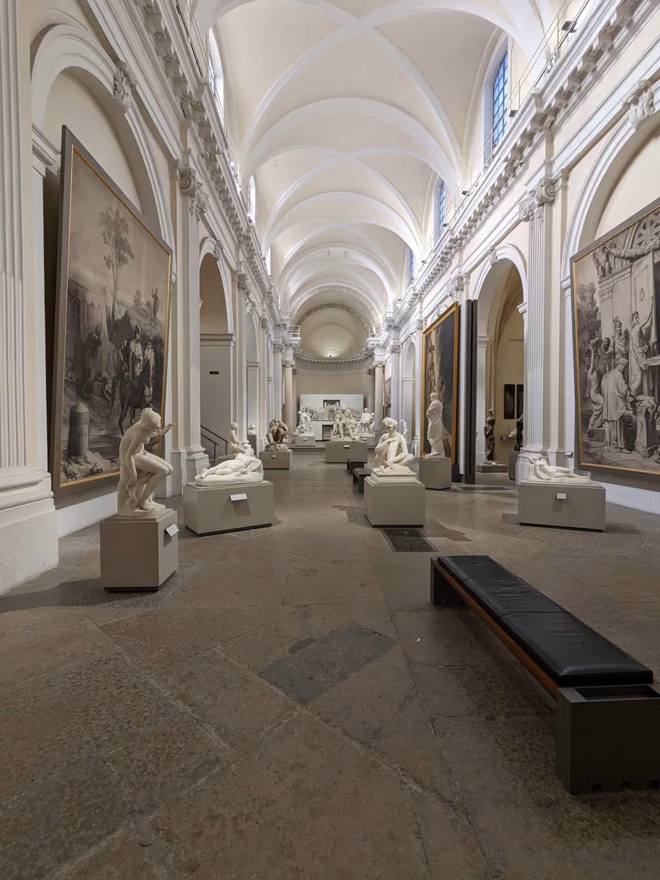 Sculpture gallery inside the Chapelle des Sculptures at the Museum of Fine Arts with white vaulted ceilings and classical statues