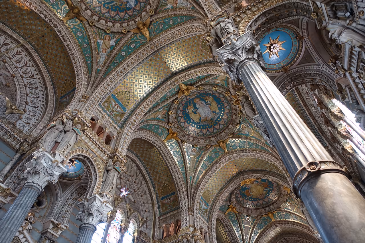 Interior of the Basilique Notre-Dame de Fourviere with ornate mosaic ceilings and columns