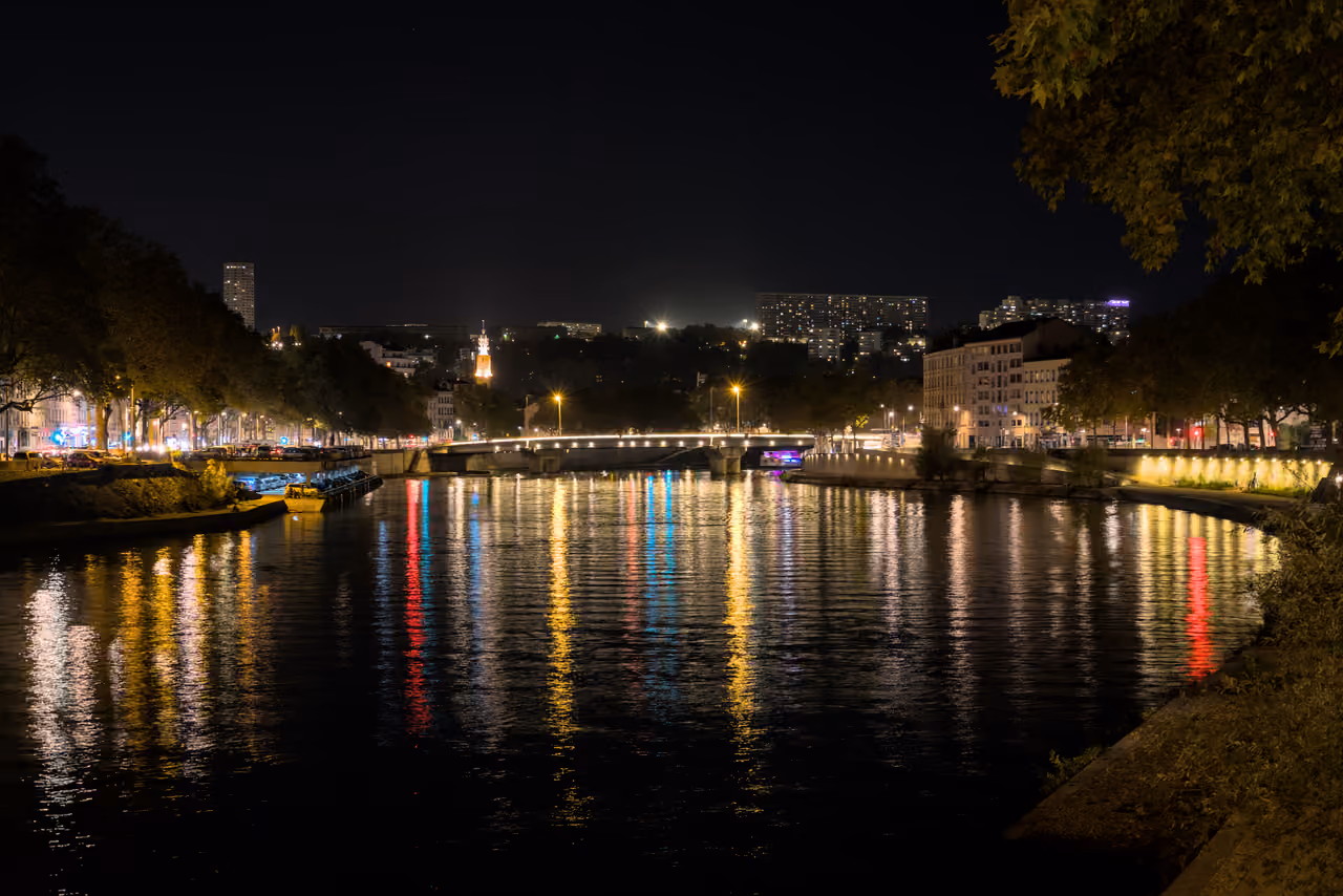 Night view of the Saone river and Clemenceau Bridge with city light reflections