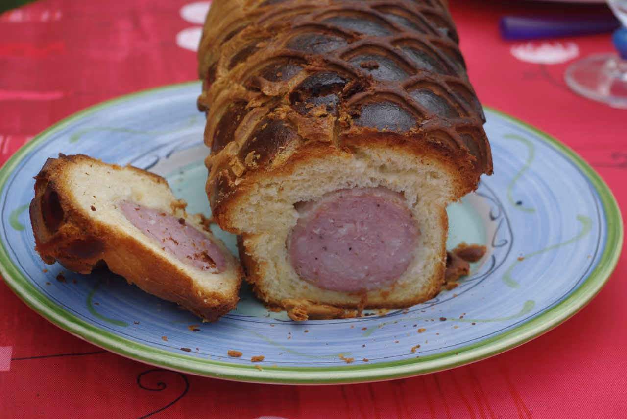 Traditional saucisson brioche sausage loaf sliced on a plate