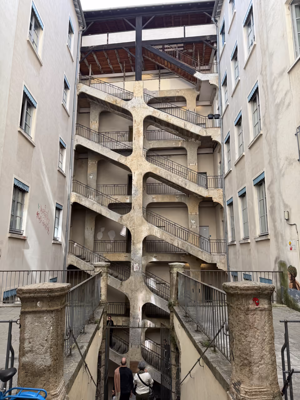 Cour des Voraces historic stone staircase in an open courtyard