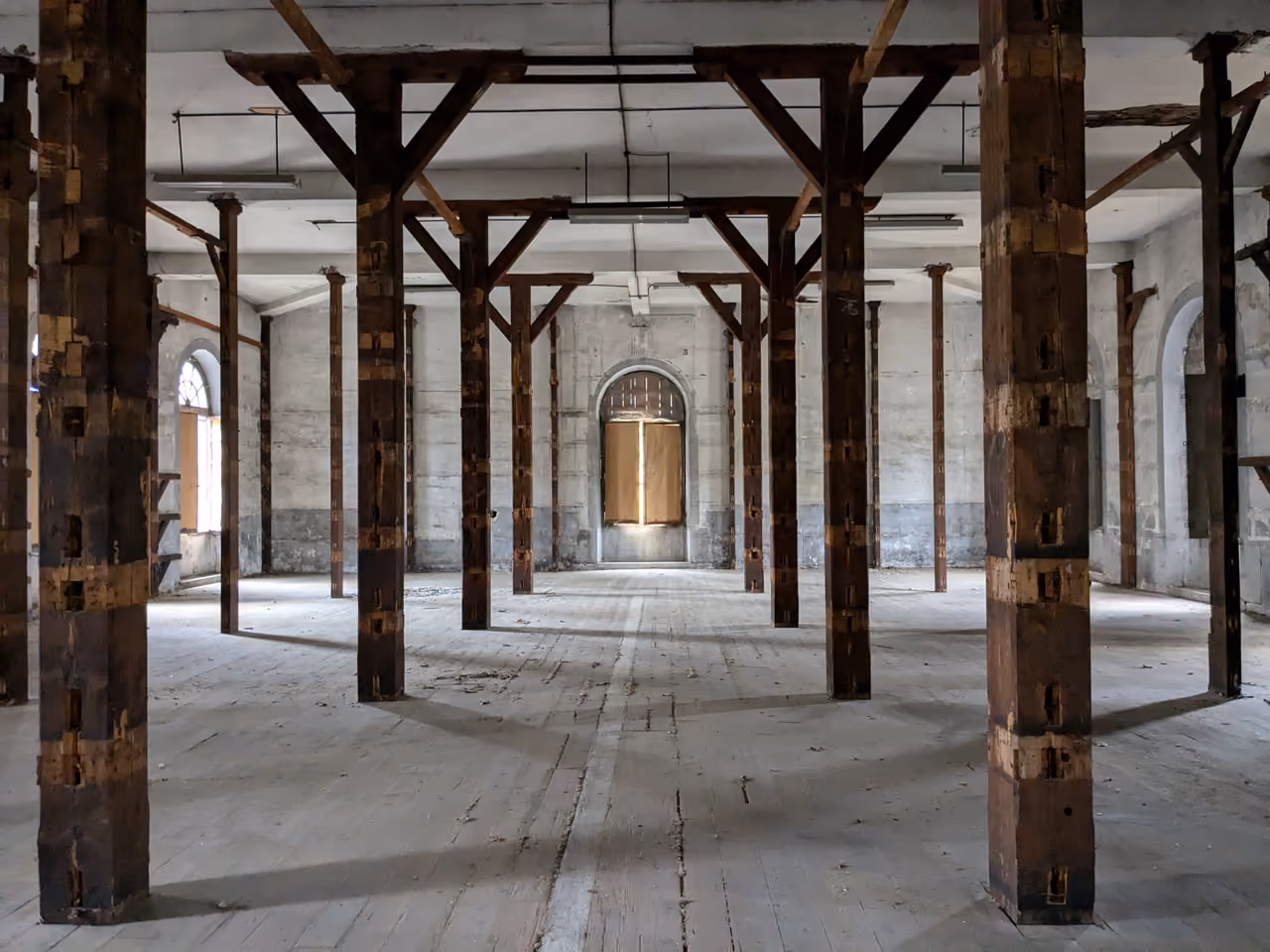 An historic weapons warehouse interior with timber columns at Caserne Sergent Blandan