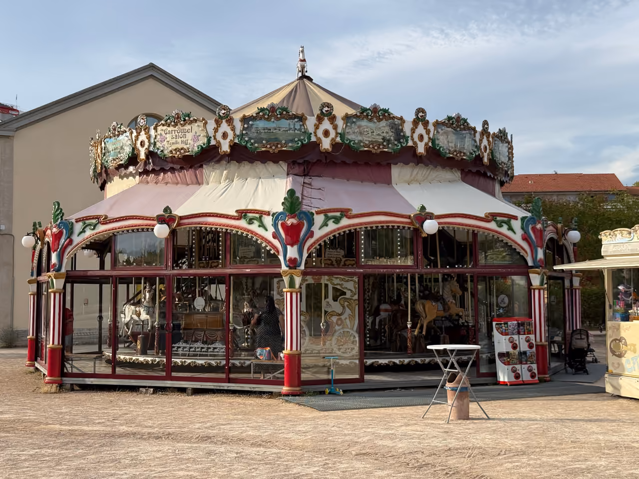 Vintage carousel at Parc Sergent Blandan featuring classic painted horses and a decorative awning