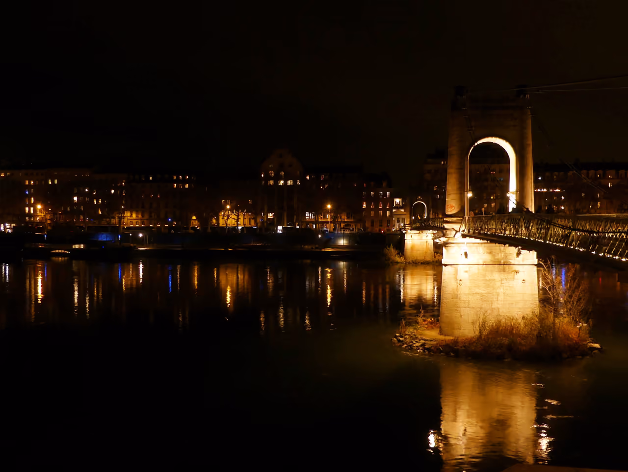 Night view of Passerelle du College footbridge lit up over the Rhone river