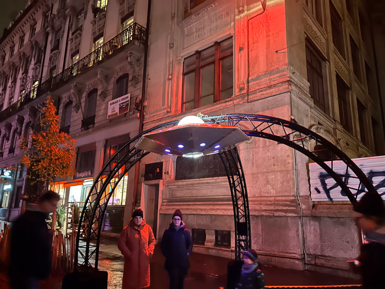UFO-shaped light installation at a street festival in Lyon France during the Fête des Lumières