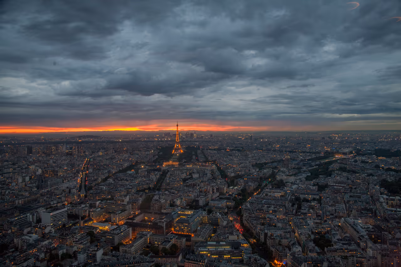 Bird's eye view of Paris at sunset, showing the city and the Eiffel Tower