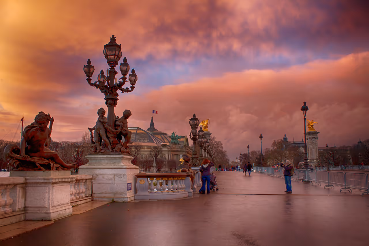 A pink sky in Paris on a bridge