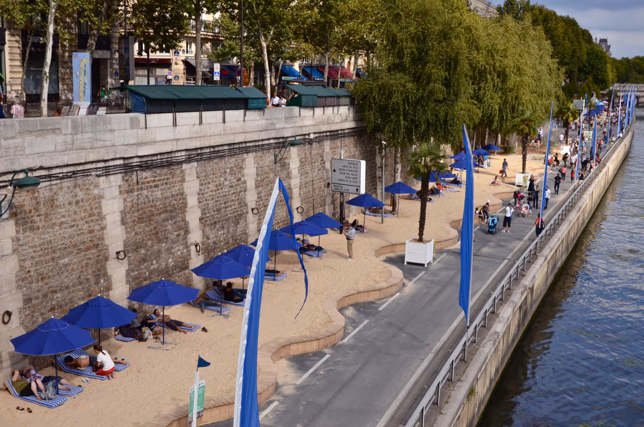 People resting on sand near the Seine, Paris