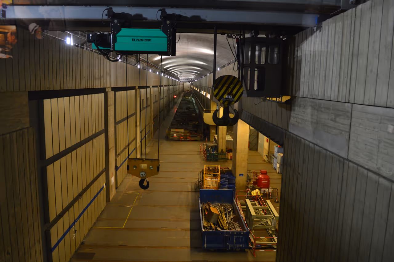 Interior view of the Rance Tidal Power Station near Saint-Malo showcasing massive overhead crane hooks and industrial machinery inside the dam turbine hall
