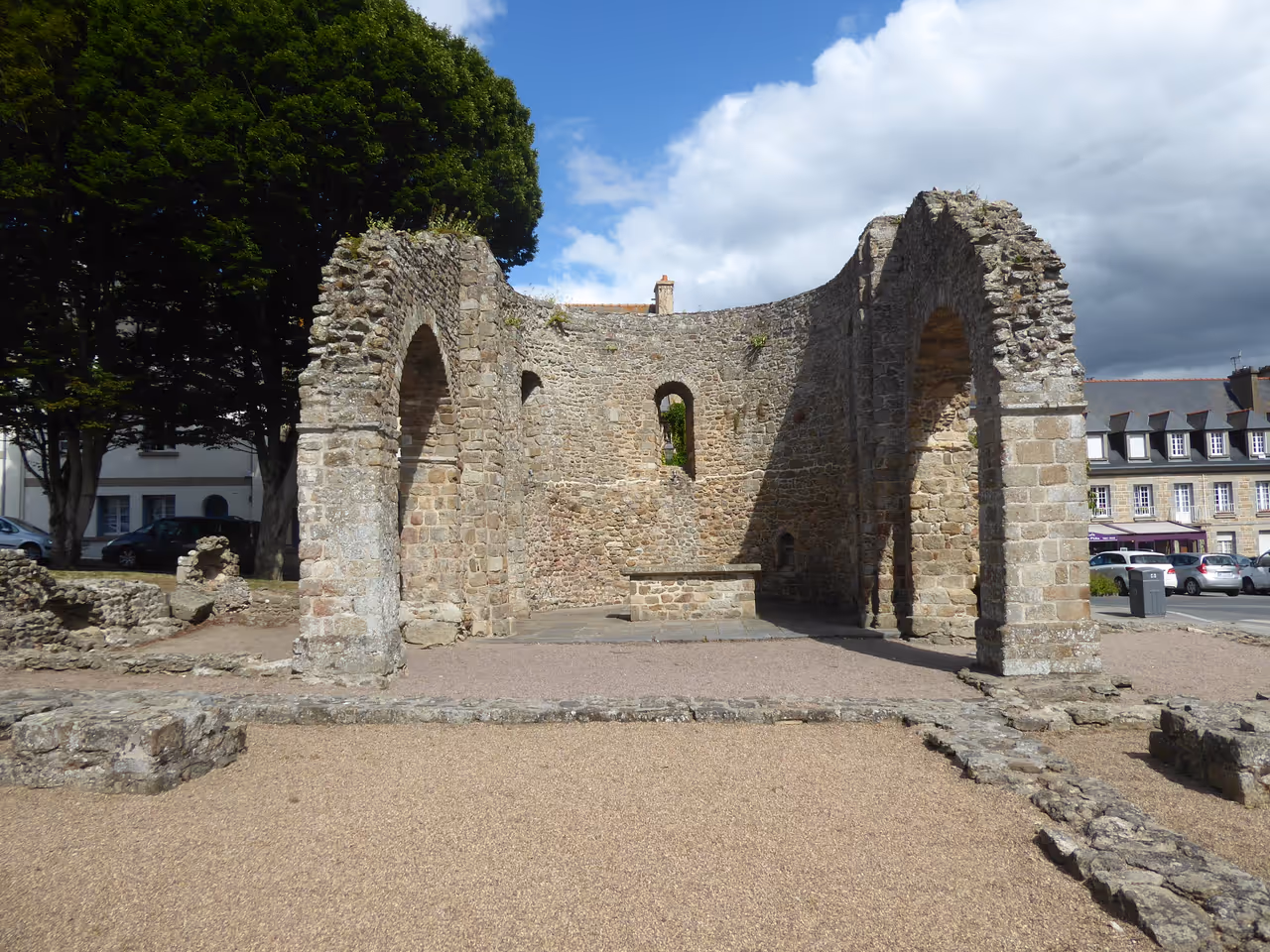 Ruins of the historic stone Cathédrale Saint-Pierre d'Aleth in Saint-Malo with open archways under a bright blue sky