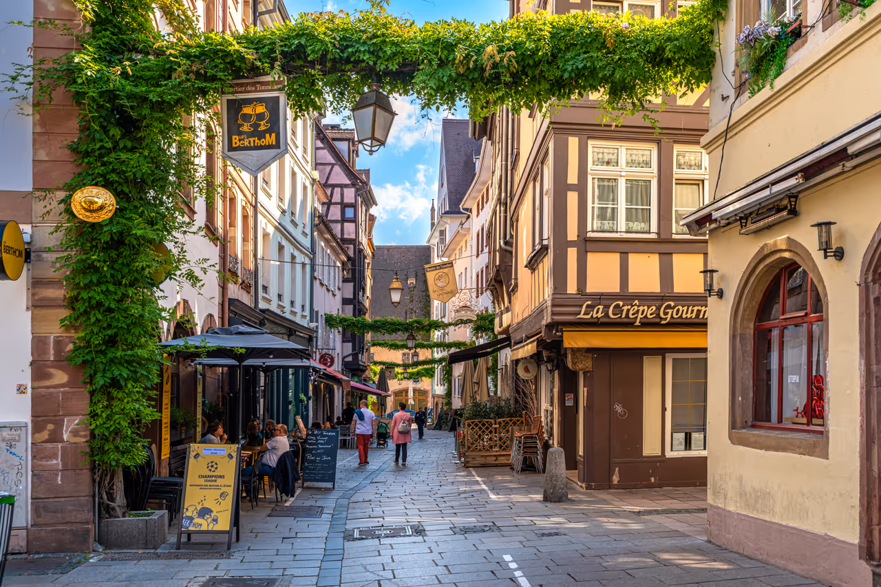 Locals and tourists relaxing at a lively bar area in Strasbourg