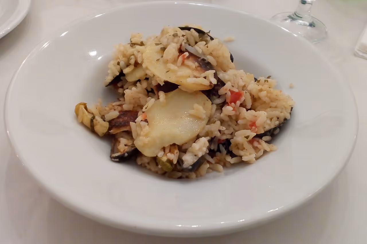 Baked rice, potatoes and mussels food in Bari