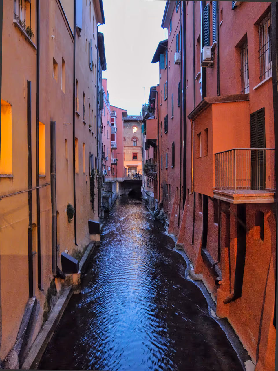 Glimpses of Bologna's Reno Canal, with the gate on Via Oberdan visible in the background
