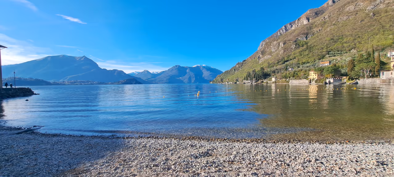 Reflections on the white beach of Lierna