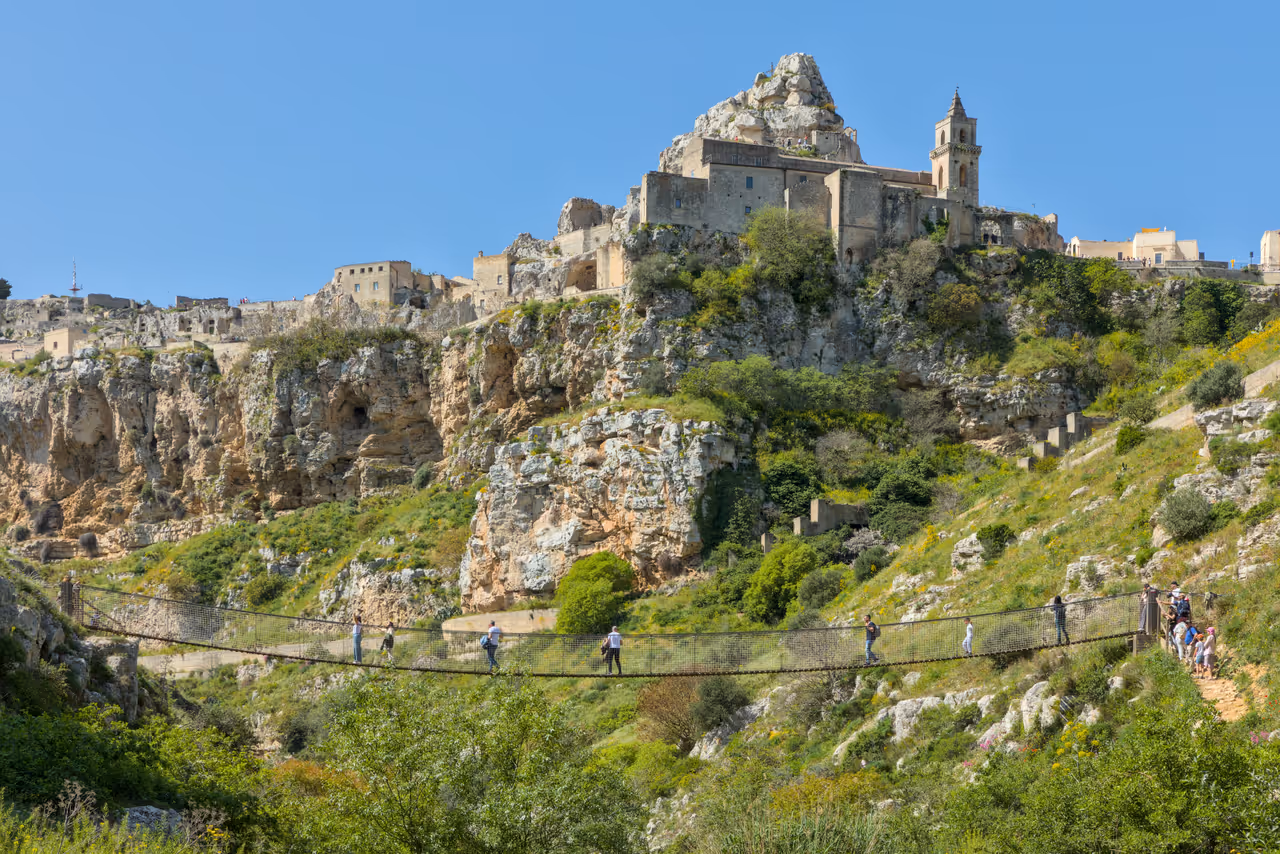 The rope bridge on trail 406, with the city behind it, Matera