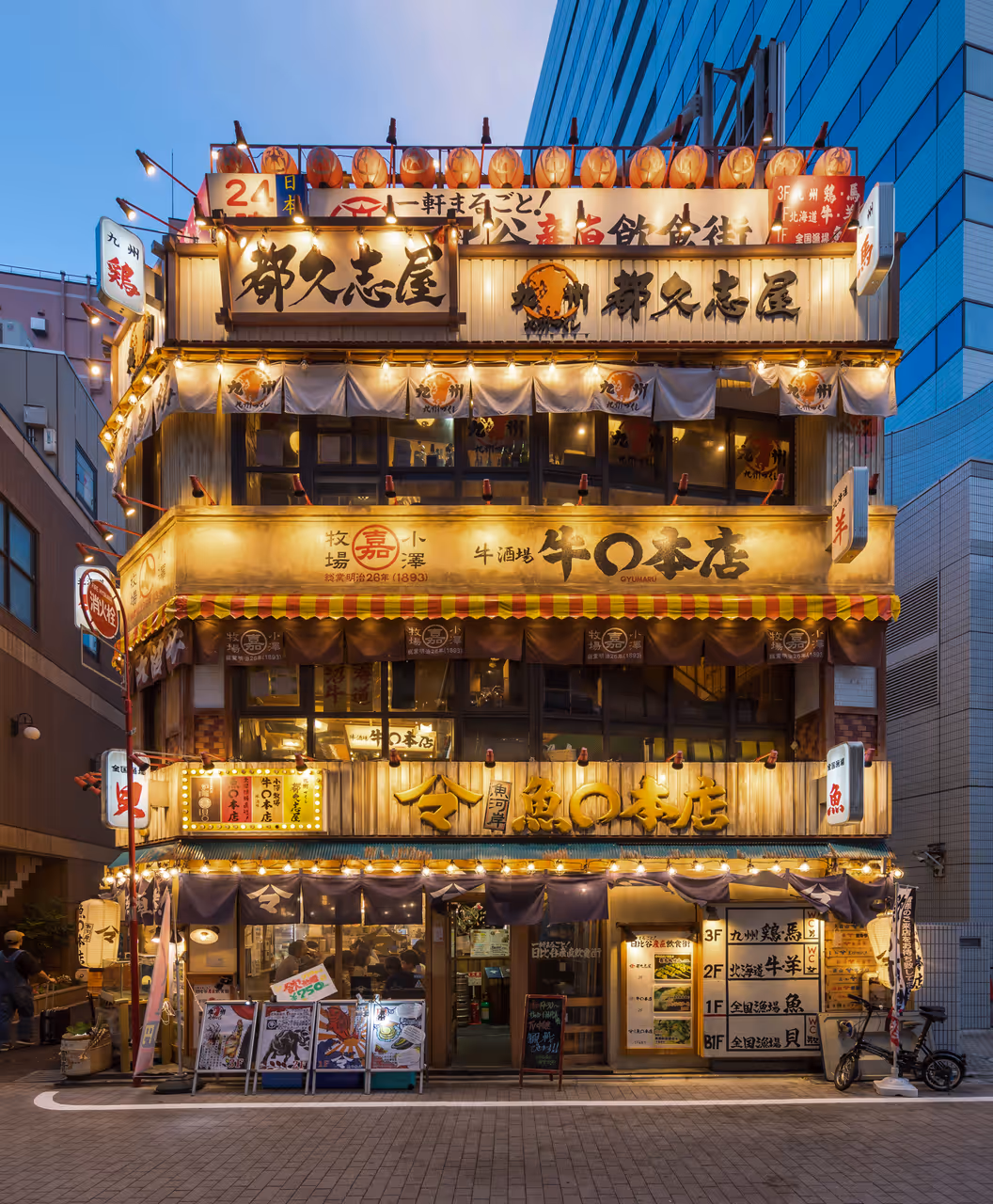 Illuminated facade of a 3-storey restaurant during the blue hour
