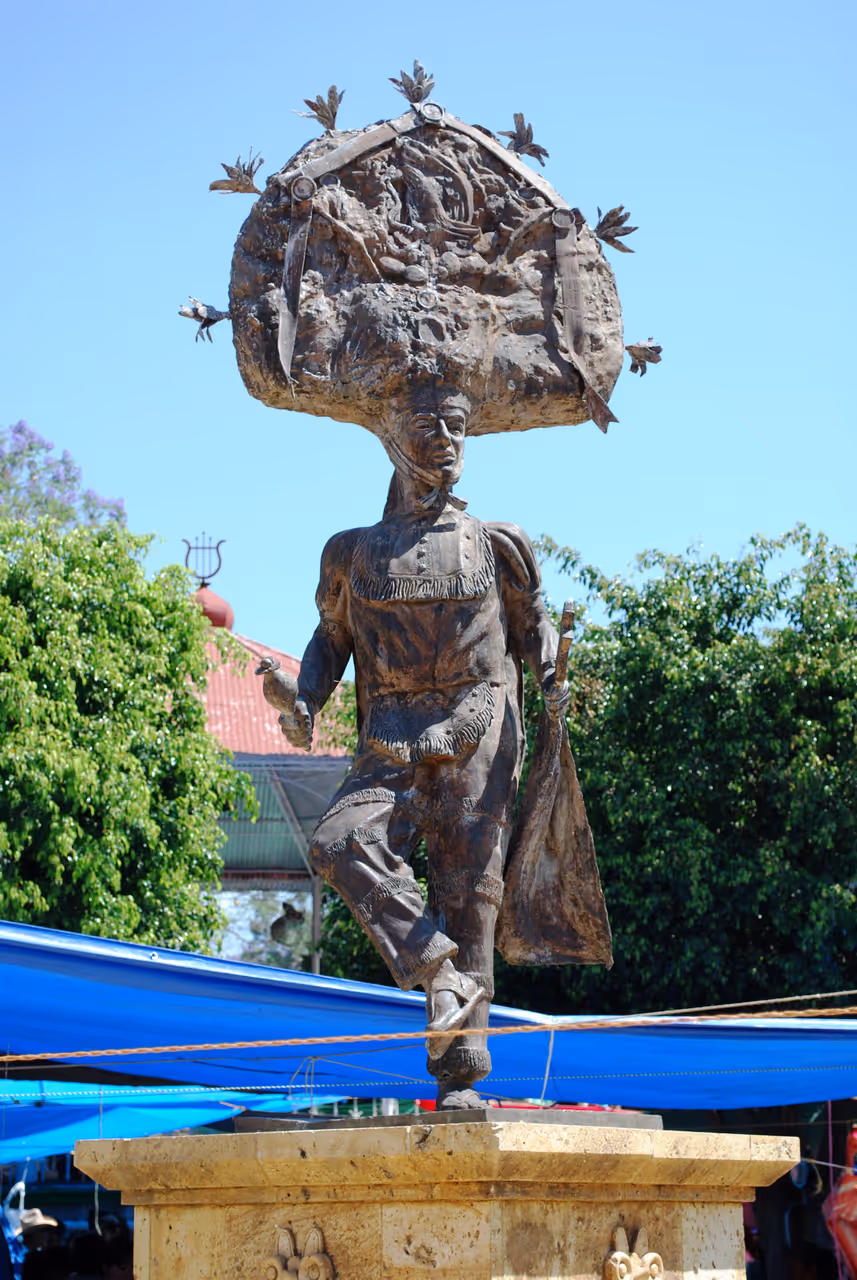Statue dedicated to the "Danza de la Pluma" in the midst of the Thursday weekly market of Zaachila, Oaxaca, Mexico