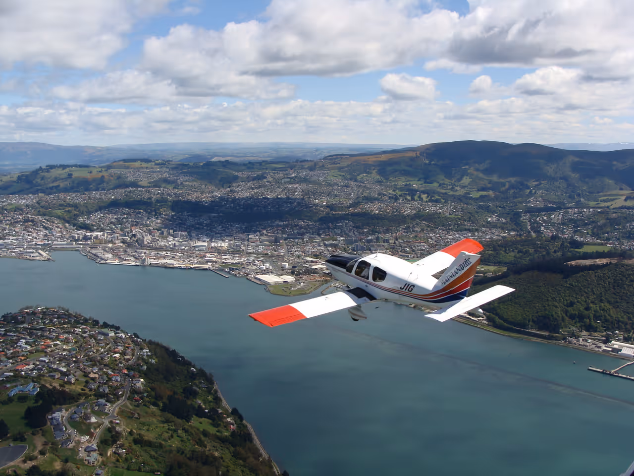 Aerial photographs of dunedin, showing a plane flying