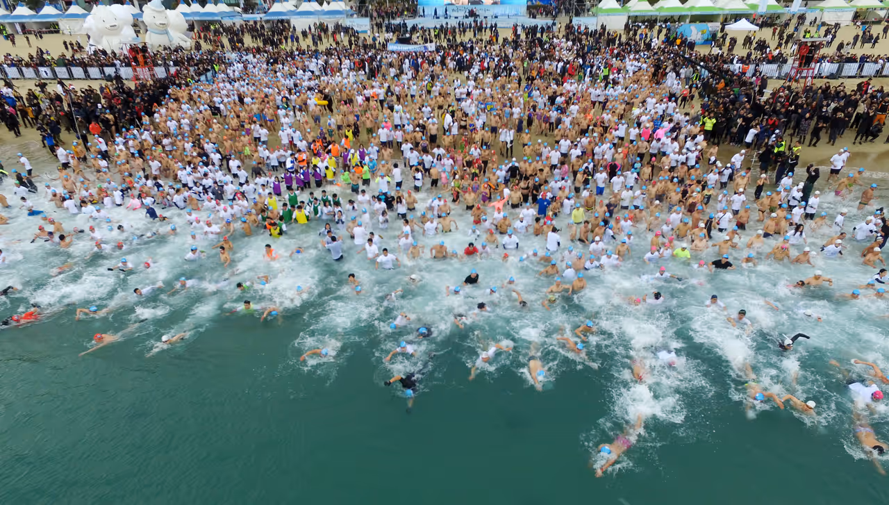 Participants enjoying winter swimming in freezing weather, just like a polar bear.