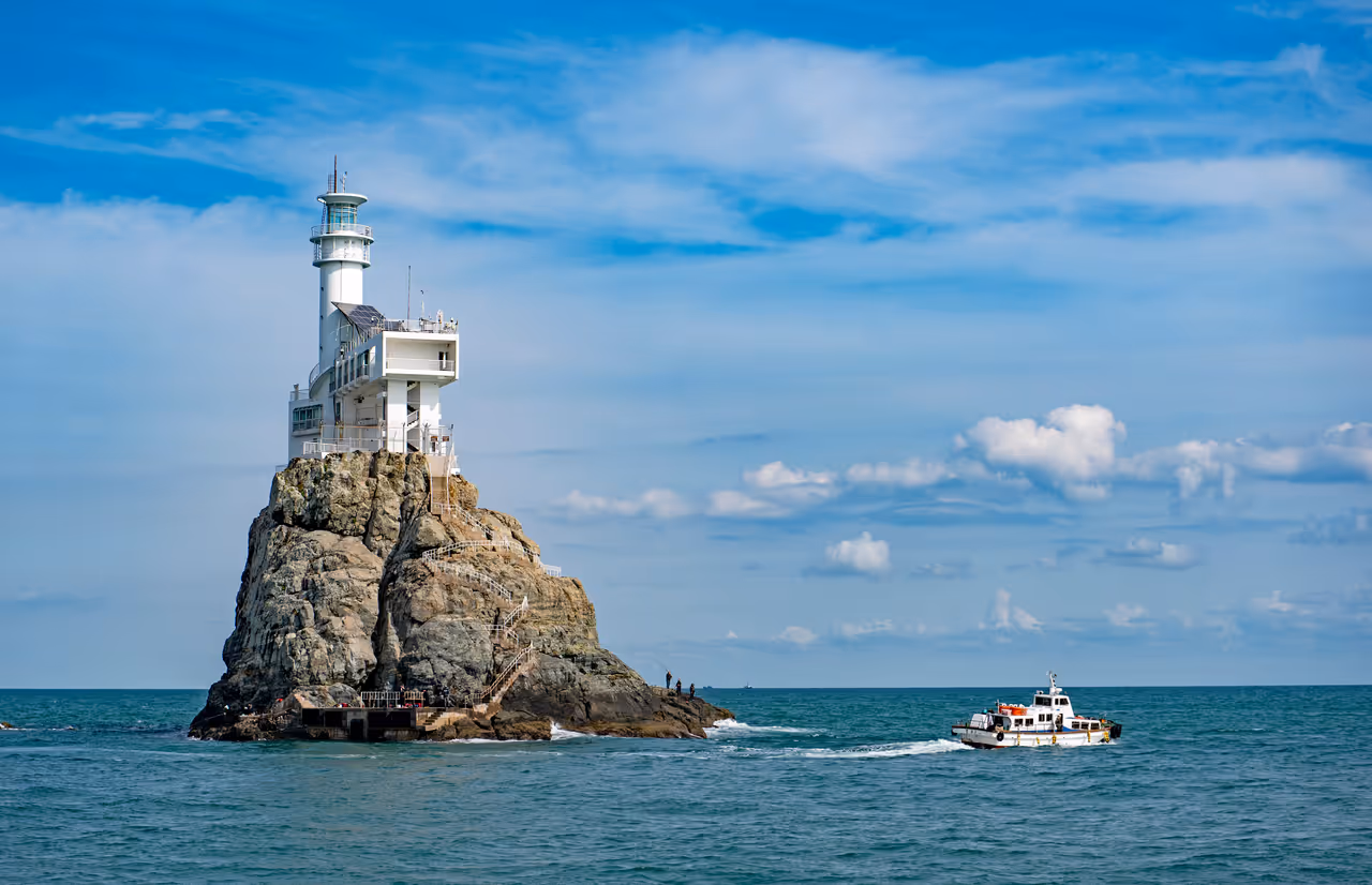 Water near busan, showing a boat and a lighthouse