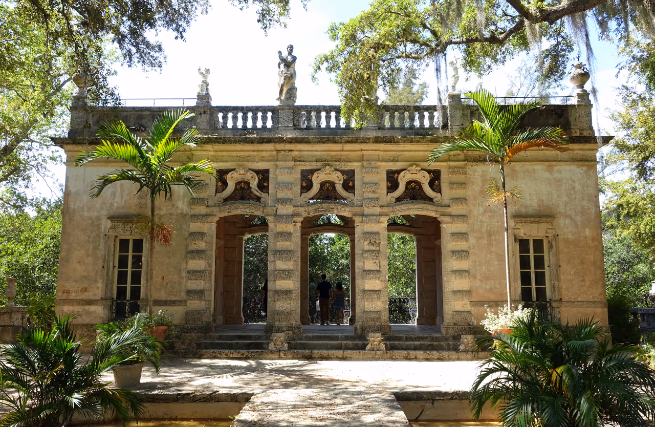 The Casino garden pavilion at Vizcaya Museum and Gardens in Miami, Florida, featuring classical Italian Renaissance-style architecture, stone arches and statues surrounded by lush tropical greenery
