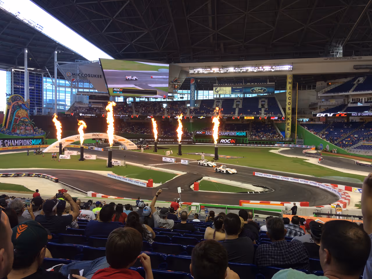 Spectators watching the 2017 Race of Champions inside Marlins Park stadium in Miami with pyrotechnics illuminating the racetrack
