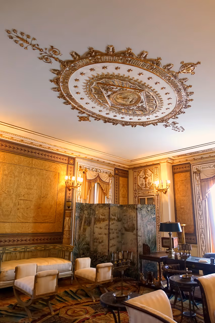 Interior view of the ornate Reception Room at Vizcaya Museum and Gardens in Miami, Florida, featuring a gilded ceiling medallion and classical furniture