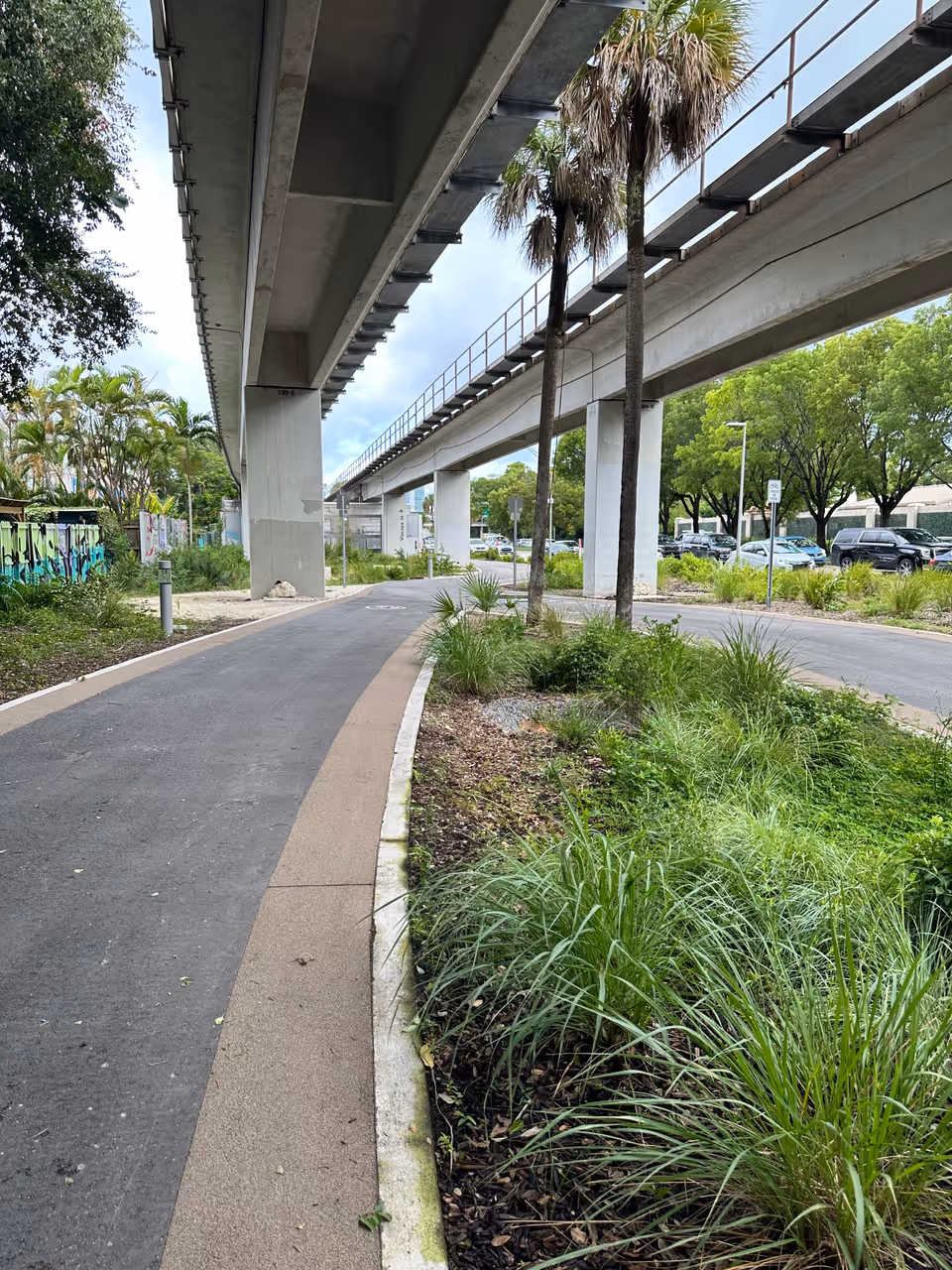 The Underline linear park and walkway winding beneath the elevated Metrorail transit tracks in Miami