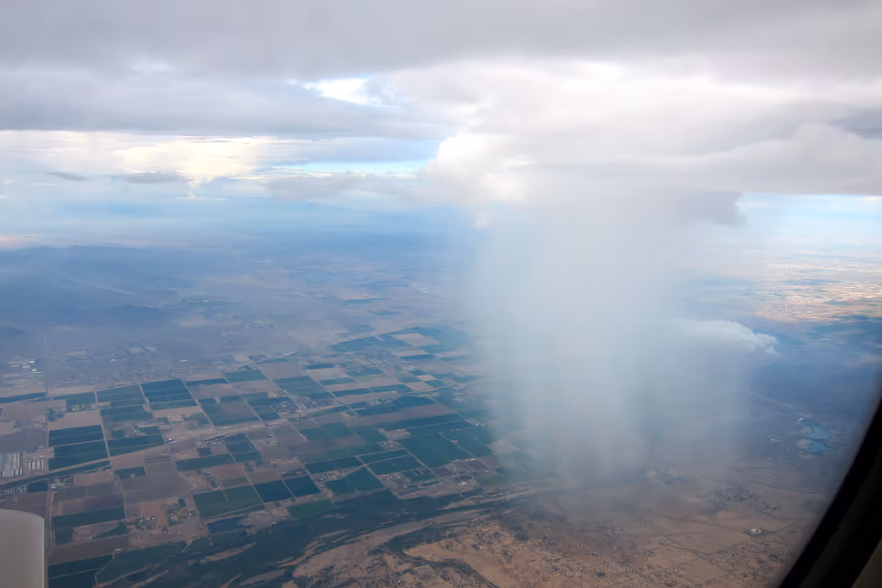 A rain cloud pours rain down in the western suburbs of Phoenix